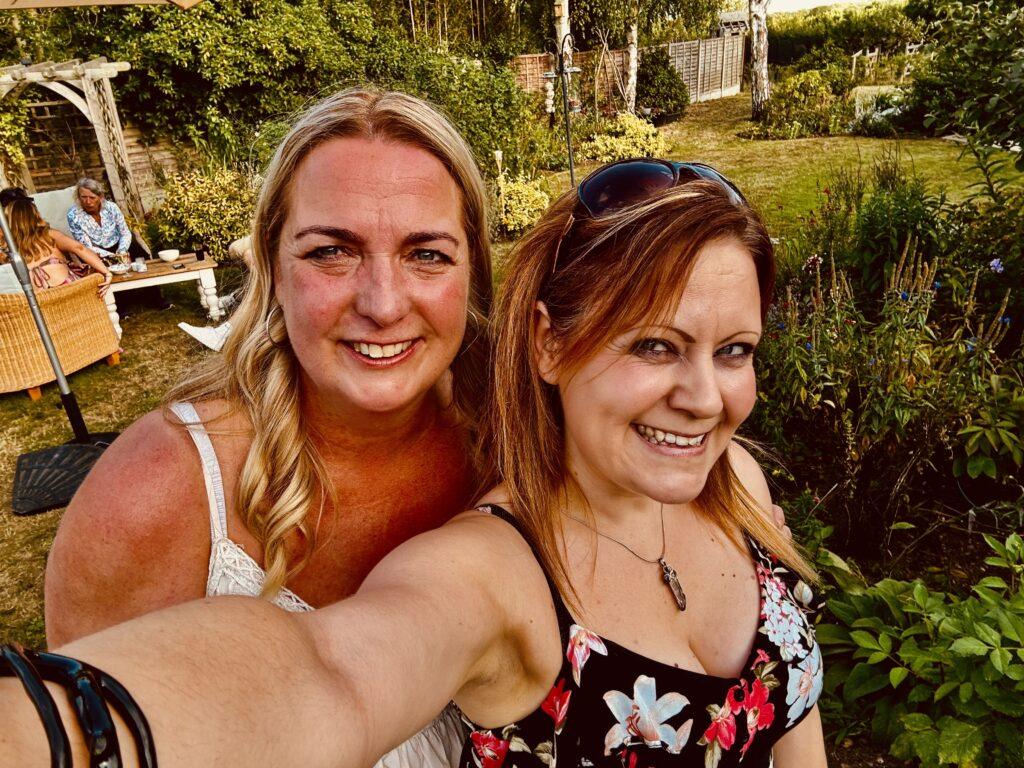 Tracy is smiling at the camera with a bride after performing as a wedding singer suffolk.